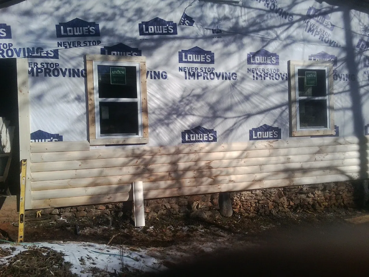 House wrap and new log siding going up on an exterior wall in Hunlock Creek