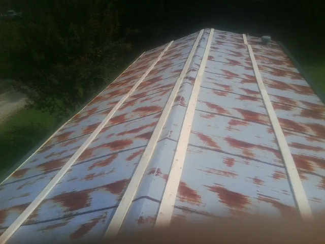 Rusted metal roof panels with new wood purlins before replacement — Storm Damage Roof Repair in Hunlock Creek by Roofing Brothers