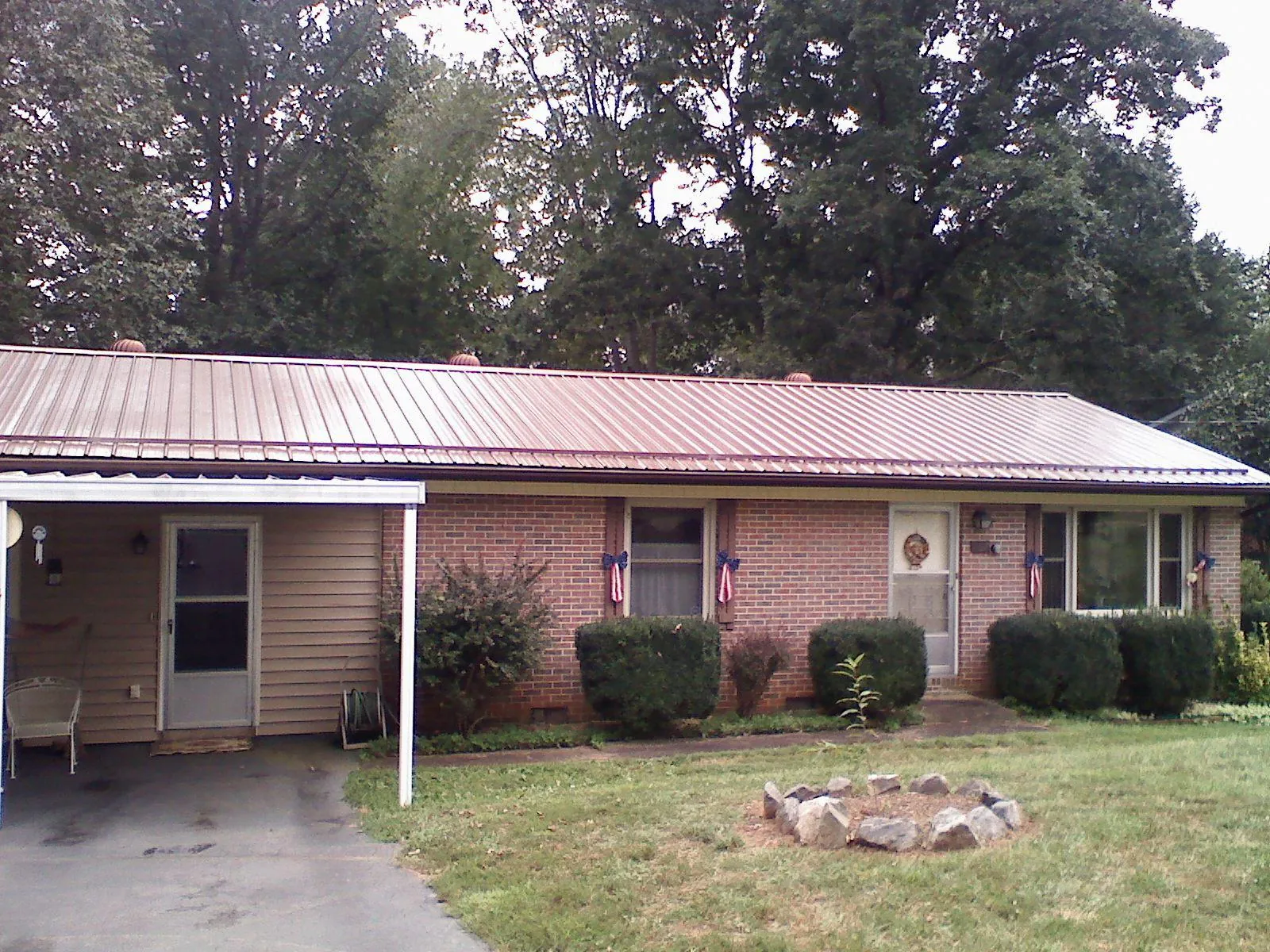 Bronze metal roof and carport on a brick ranch home — Roof Repair work by our crew in Hunlock Creek